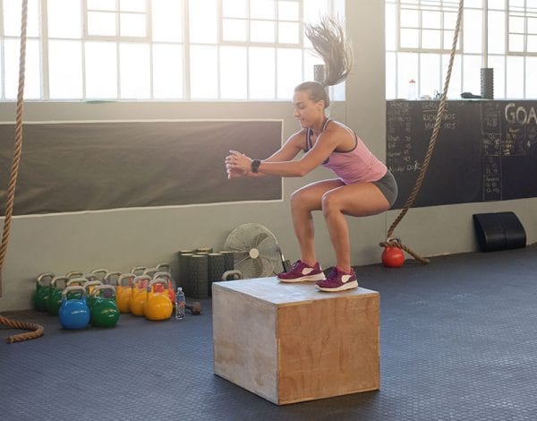 vital health and crossfit - women jumping on box doing crossfit